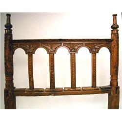 A CARVED OAK BEDSTEAD