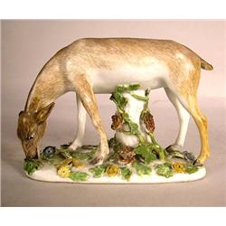A STAFFORDSHIRE FIGURE OF A DEER FEEDING
