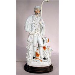 A STAFFORDSHIRE FIGURAL OF A HUNTER WITH DOG