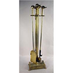 A CAST BRASS WROUGHT IRON DUCK HEAD FIREPLACE STAND AND TOOL SET