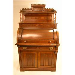 AN AESTHETIC MOVEMENT FIGURED WALNUT CYLINDER FRONT DESK