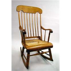 A MAPLE, PINE, AND BEECHWOOD CANED SEAT ROCKING CHAIR