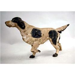 A BLACK AND WHITE PAINT-DECORATED SETTER FORM DOOR STOP