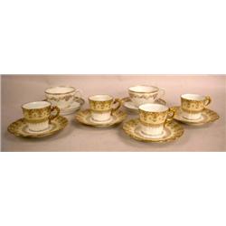 A SET OF C. AHRENFELDT LIMOGES CUPS AND SAUCERS