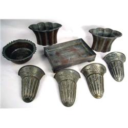 A SET OF FOUR COPPER EMBOSSED WALL POCKETS