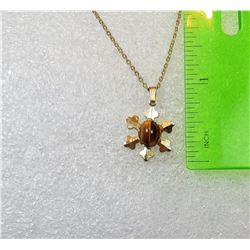 21)  GOLD PLATED PENDANT WITH TIGER'S