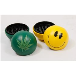 LOT OF TWO GRINDERS (HAPPY FACE, PLANT LEAF)
