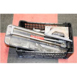 TWO TILE CUTTERS WITH TROWELS.