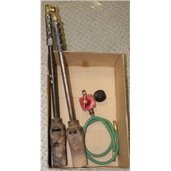 BOX W/ 2 CAST IRON TORCHES AND PROPANE REGULATOR.