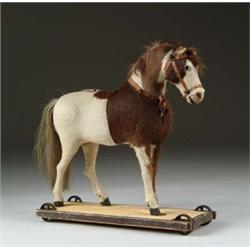 HIDE-COVERED HORSE ON WHEELED WOODEN BASE