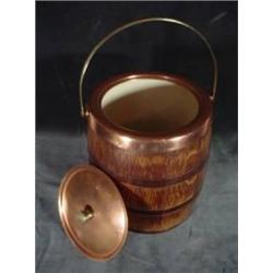 WOODEN HUMIDOR FASHIONED AFTER A BARREL WITH COPPERTONE HARDWARE. 5.5"X5.5".