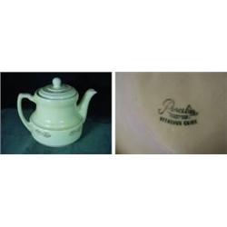 PORCELIER TEA POT MARKED VITREOUS CHINA IN A CREAM COLOR WITH RUST BORDER AND FLORAL DESIGN. 5.5"X8.