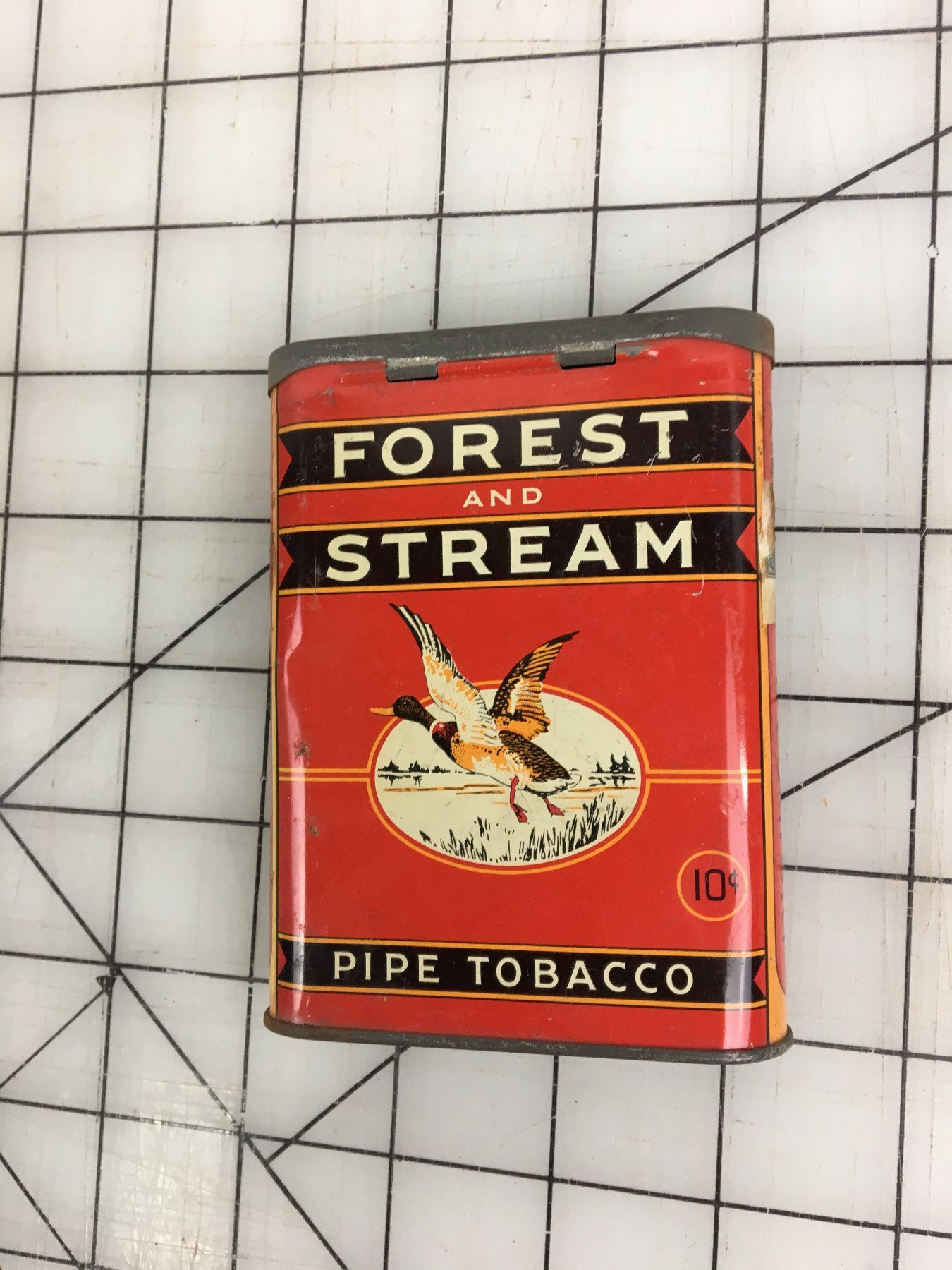 FOREST AND STREAM’ PIPE TOBACCO POCKET TIN Schmalz Auctions