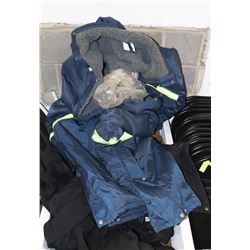 STACK OF WORK COVERALLS AND JACKETS