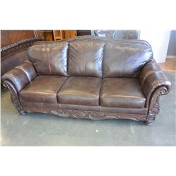 ASHLEY FLOOR MODEL BROWN LEATHER AND CARVED ROLLED ARM SOFA RETAIL $1699