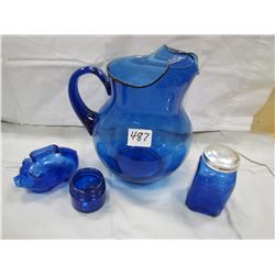 LOT OF 4 PIECES OF BLUE GLASS (PITCHER, PIGGY BANK, PEPPER SHAKER AND JAR)