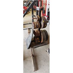 RACK OF ASSORTED WEIGHT PLATES W/ BARBELL