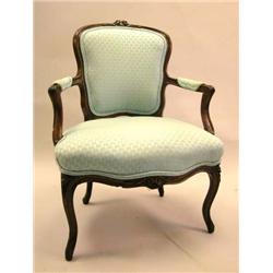 A LOUIS XV STYLE CARVED WALNUT FAUTEUIL