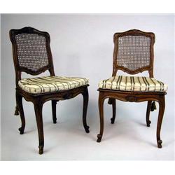 A PAIR OF LOUIS XV STYLE CARVED AND CANED CHAISES