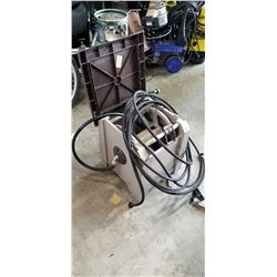 GARDEN HOSE ON REEL AND REEL HOLDER