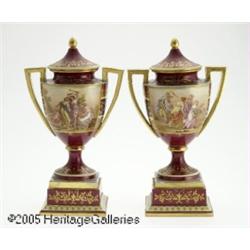 A PAIR OF CONTINENTAL PORCELAIN LIDDED URNS RVien