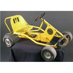 Yellow metal childs pedal car