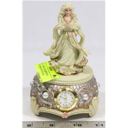 MUSICAL TABLE CLOCK WITH STATUE OF PRAYING FIGURE