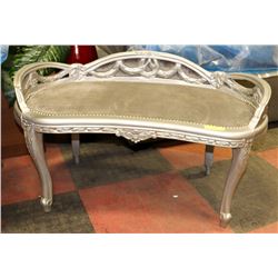 CURVED ORNATE BENCH WITH GREY UPHOLSTRY.