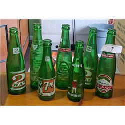7 VINTAGE GREEN GLASS POP BOTTLES