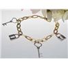 Image 1 : 14kt two-tone bracelet with lock and key charms 1