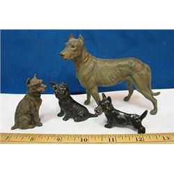 Collection of four metal dogs.  One has a broken 