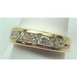 Mans' 14kt yellow gold channel set diamond band .
