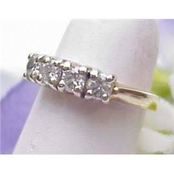 Lady's 14kt two-tone ring with four diamonds appr