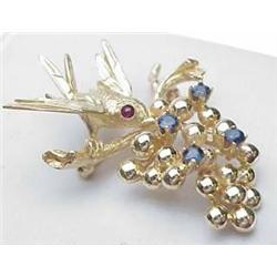 14kt yellow gold pin bird on branch with sapphire