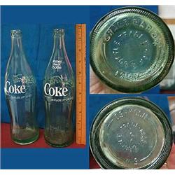 Two 26oz 60's era Coke bottles.  One from Oshkosh
