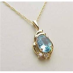 14kt yellow gold blue topaz pendant on a 18" chai