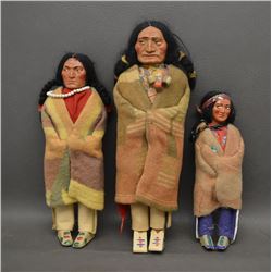 THREE SKOOKUM DOLLS