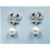 A pair of 18 kt. white gold and diamond earrings.