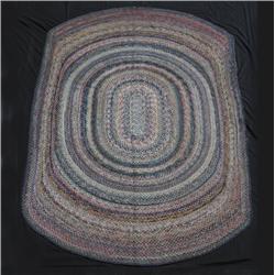 INTERESTING HAND BRAIDED OVAL RUG