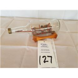 carved bobsled in a bottle