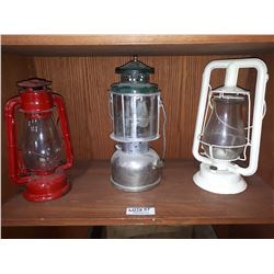 THREE CLEAR GLASS OIL LANTERNS
