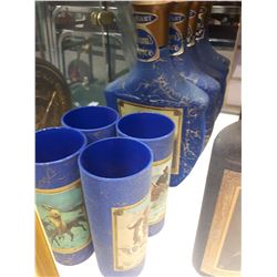 FIVE BLUE JIM BOTTLES WITH FOUR MATCHING GLASSES
