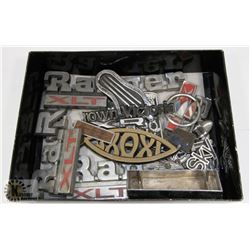 BOX OF ASSORTED AUTO BADGES AND INSIGNIA PIECES.