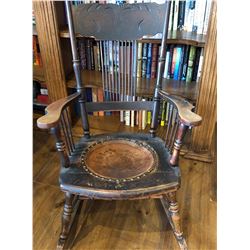 ANTIQUE ROCKING CHAIR W / LEATHER SEAT. LEATHER HAS BROKEN AWAY FROM A FEW STUDS.