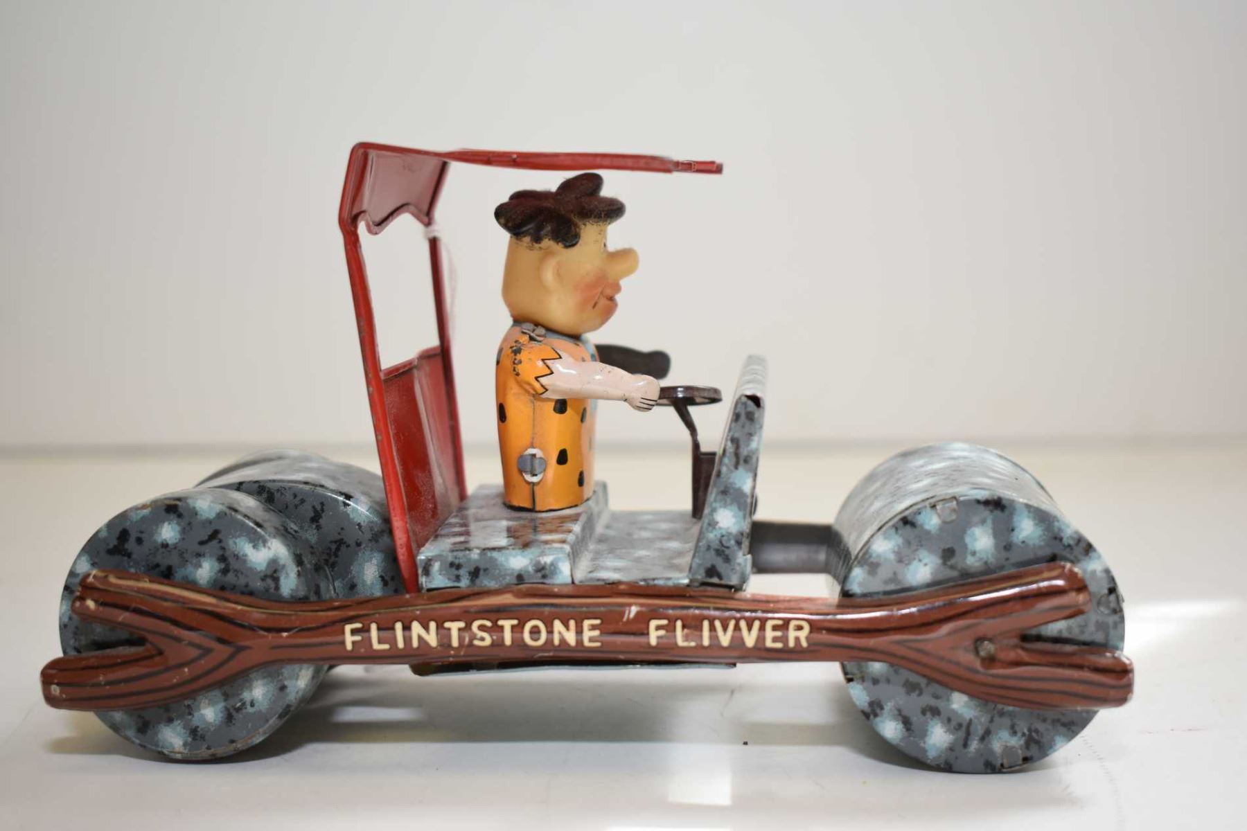 Flintstone Flivver pressed tin, friction car made by Marx, 7" in length