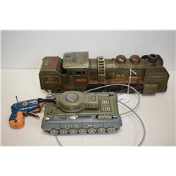 Two vintage tin toys including a mechanical cable operated tank and a battery operated train