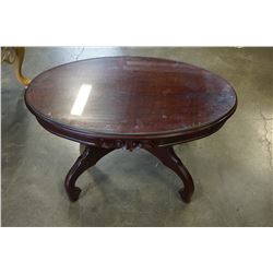 OVAL GLASS TOP CARVED COFFEE TABLE