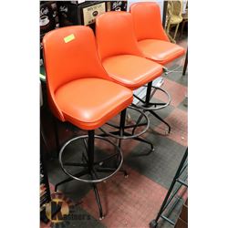 3 ORANGE SWIVEL BAR STOOLS.
