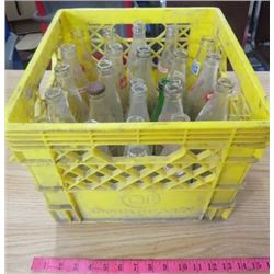 LOT OF 24 POP BOTTLES WITH YELLOW PLASTIC CRATE (VARIOUS BRANDS)