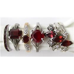 7-STERLING RINGS WITH RED GEMS.
